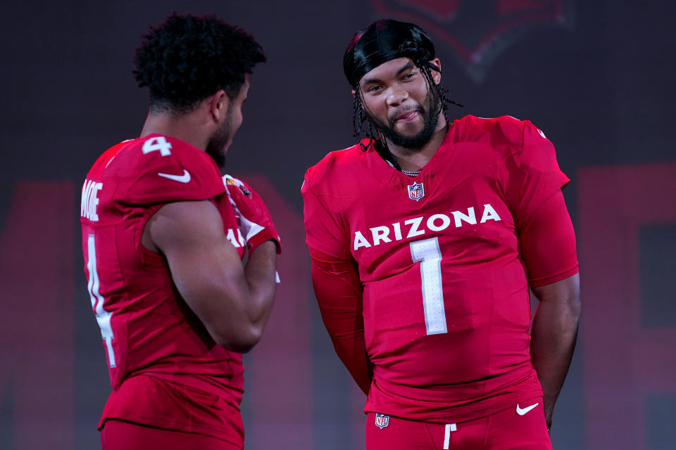 Arizona Cardinals quarterback Kyler Murray (1) and wide receiver Rondale Moore showcase the NFL football teams' new uniforms for the 2023 season, Thursday, April 20, 2023, in Phoenix. (AP Photo/Matt York)