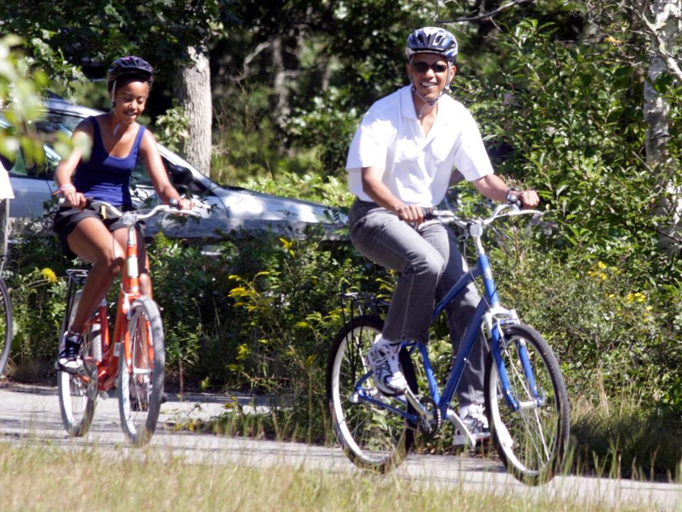 Barack Obama biking with his daughter