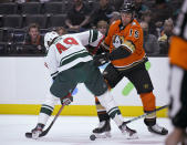 Minnesota Wild center Victor Rask (49) and Anaheim Ducks center Ryan Getzlaf (15) fight for the puck during the first period of an NHL hockey game Friday, Oct. 15, 2021, in Anaheim, Calif. (AP Photo/John McCoy)