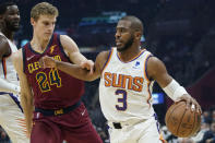 Phoenix Suns' Chris Paul (3) drives against Cleveland Cavaliers' Lauri Markkanen (24) during the first half of an NBA basketball game Wednesday, Nov. 24, 2021, in Cleveland. (AP Photo/Tony Dejak)