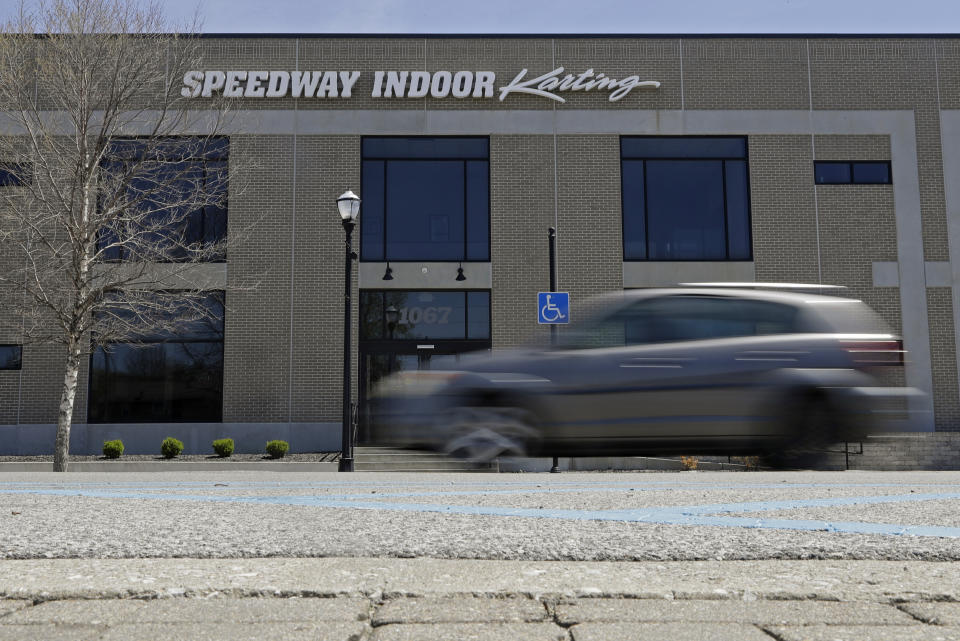 A car drives past Speedway Indoor Karting, Tuesday, April 21, 2020, in Indianapolis. Former IndyCar driver Sarah Fisher found the perfect spot for her new venture, Speedway Indoor Karting, just a short stroll from Indianapolis Motor Speedway which is closed due to the coronavirus pandemic. (AP Photo/Darron Cummings)