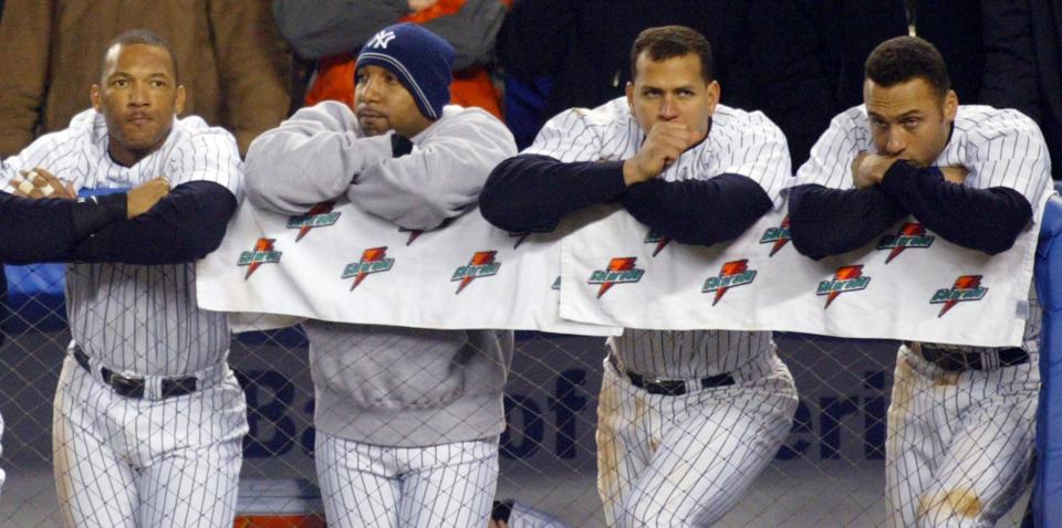 Members of the Yankees — Gary Sheffield, Enrique Wilson, Alex Rodriguez and Derek Jeter — lean on the dugout fence during the Yankees 4-2 loss to the Red Sox in Game 6 of the American League Championship Series in New York on October 19, 2004.