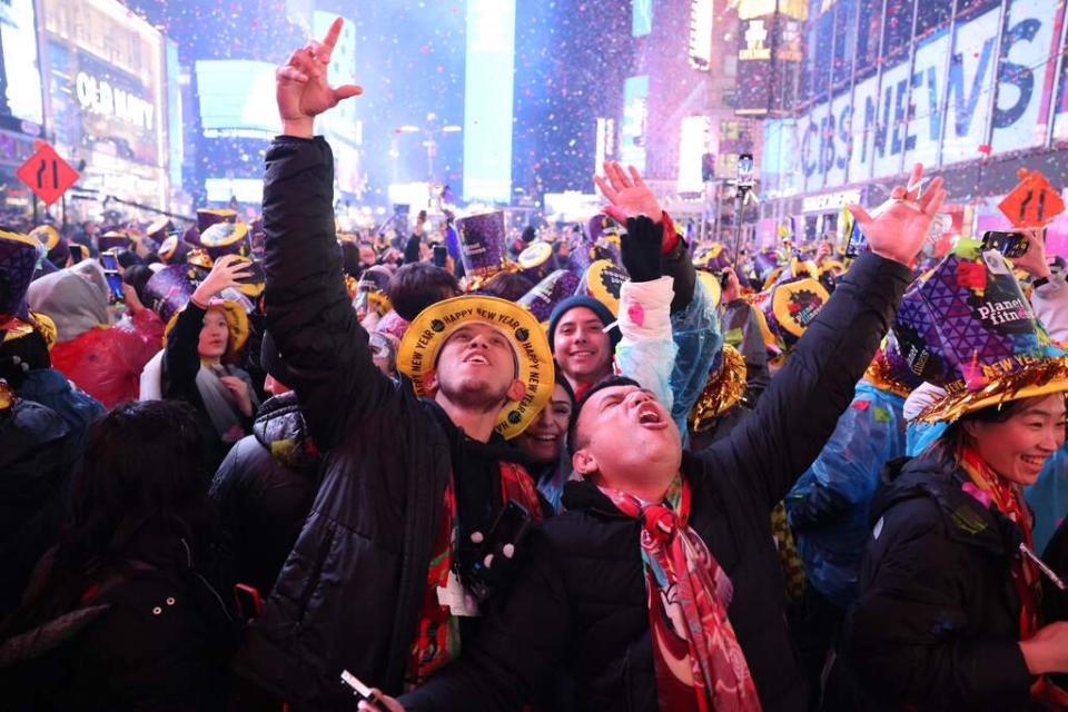 Onlookers cheer as confetti fills the air to mark the beginning of the new year, in Times Square, New York City, on January 1, 2023.