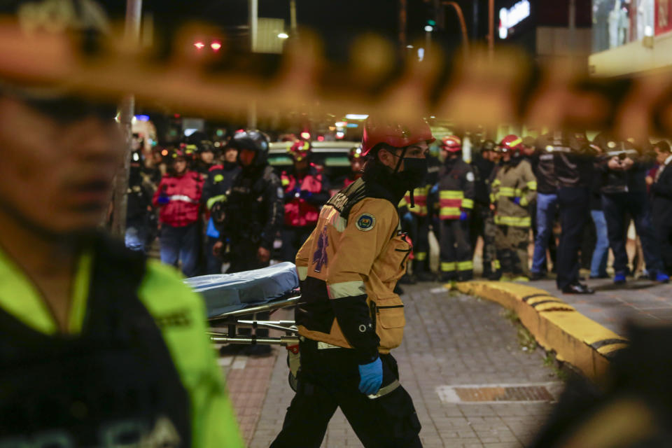 Police and emergency workers stand outside the clinic where presidential candidate Fernando Villavicencio was taken after he was shot and killed after a campaign rally in Quito, Ecuador, Wednesday, Aug. 9, 2023. (AP Photo/Juan Diego Montenegro)