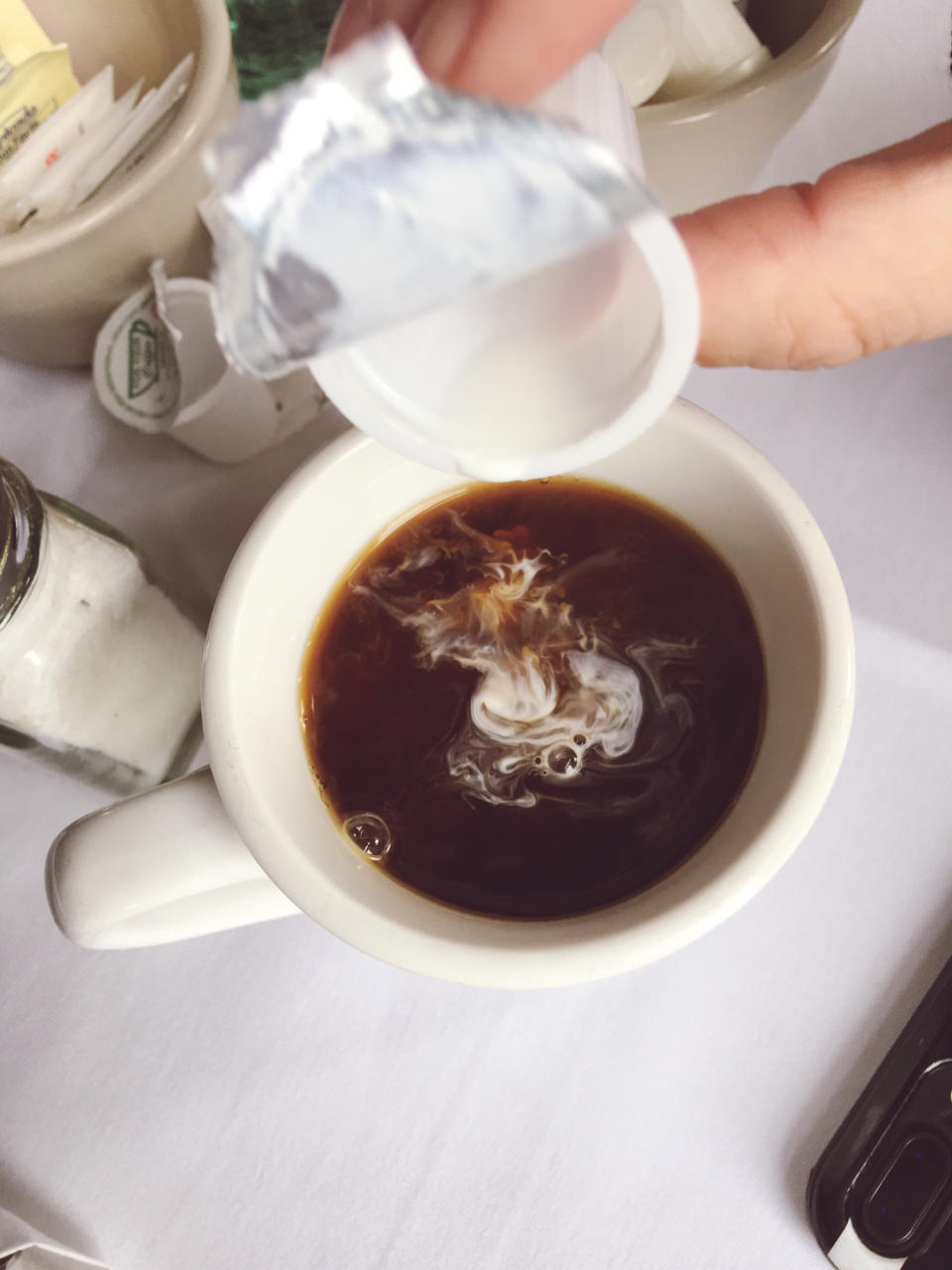 Creamer in a cup of hot coffee