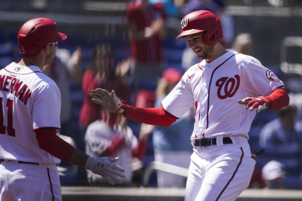 Washington Nationals Trea Turner, right, celebrates his solo home run with Ryan Zimmerman during the third inning of a baseball game against the Arizona Diamondbacks at Nationals Park, Sunday, April 18, 2021, in Washington. (AP Photo/Alex Brandon)