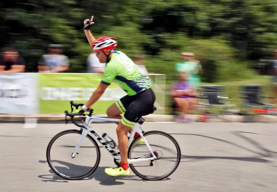 A rider celebrates finishing his Pelotonia ride in New Albany in 2018.