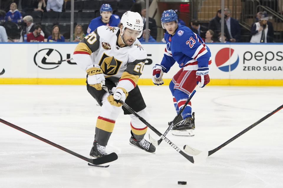 Vegas Golden Knights center Chandler Stephenson (20) controls the puck ahead of New York Rangers defenseman Adam Fox (23) during the second period of an NHL hockey game, Friday, Dec. 17, 2021, at Madison Square Garden in New York. (AP Photo/Mary Altaffer)