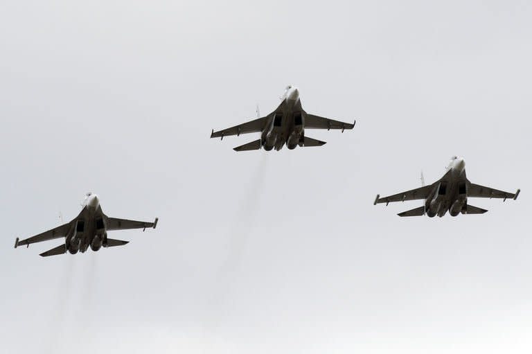 Venezuelan Air Force Russian-made Sukhoi Su-30 figthers overfly the caravan taking the coffin with the remains of late Venezuelan President Hugo Chavez to former 4 de Febrero barracks in Caracas on March 15, 2013