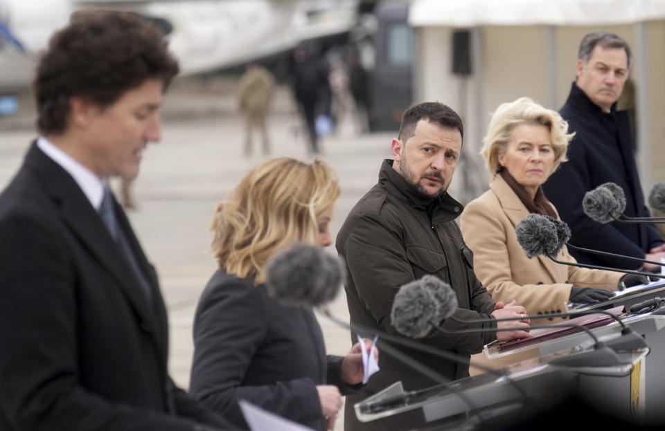 Ukrainian President Volodymyr Zelenskyy listens as Canadian Prime Minister Justin Trudeau speaks during a ceremony at Hostomel Airport in Kyiv, Ukraine on Saturday, Feb. 24, 2024. The ceremony to mark the 2nd anniversary of the start of the war in Ukraine was also attended by Italian Premier Giorgia Meloni, second left, European Commission President Ursula von der Leyen, second right, and Belgian Prime Minister Alexander De Croo (right)..(Nathan Denette /The Canadian Press via AP)