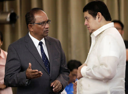 John Gomes (L), Bangladesh's ambassador to the Philippines, gestures while talking to senator Teofisto Guingona Jr., during a money laundering hearing at a hotel in metro Manila, Philippines May 19, 2016. REUTERS/Czar Dancel