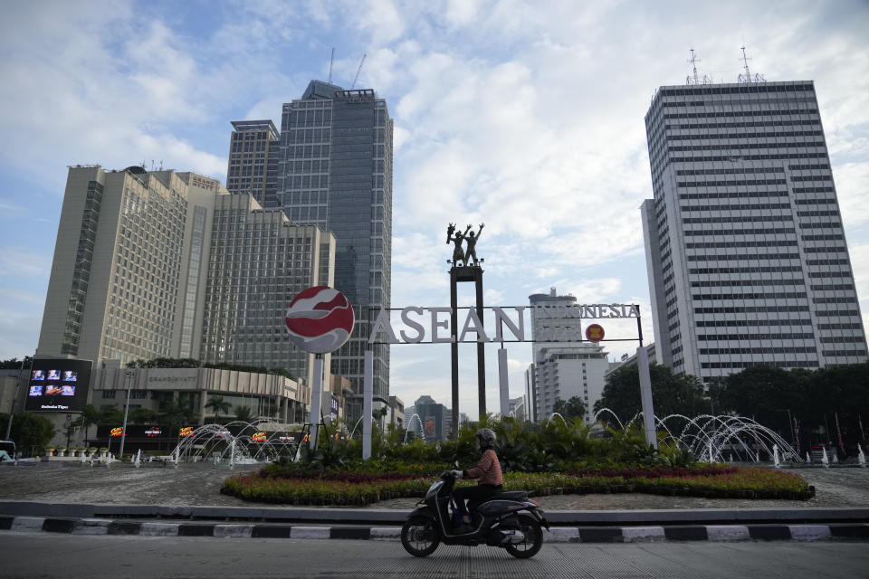 A motorist rides past a sign of the Association of Southeast Asian Nations (ASEAN) foreign ministers' meeting in Jakarta, Indonesia, Monday, July 10, 2023. Myanmar's prolonged civil strife, tensions in the disputed South China Sea and concern over arms buildups in the region are expected to dominate the agenda when Southeast Asia's top diplomats gather for talks this week in Indonesia. (AP Photo/Achmad Ibrahim)