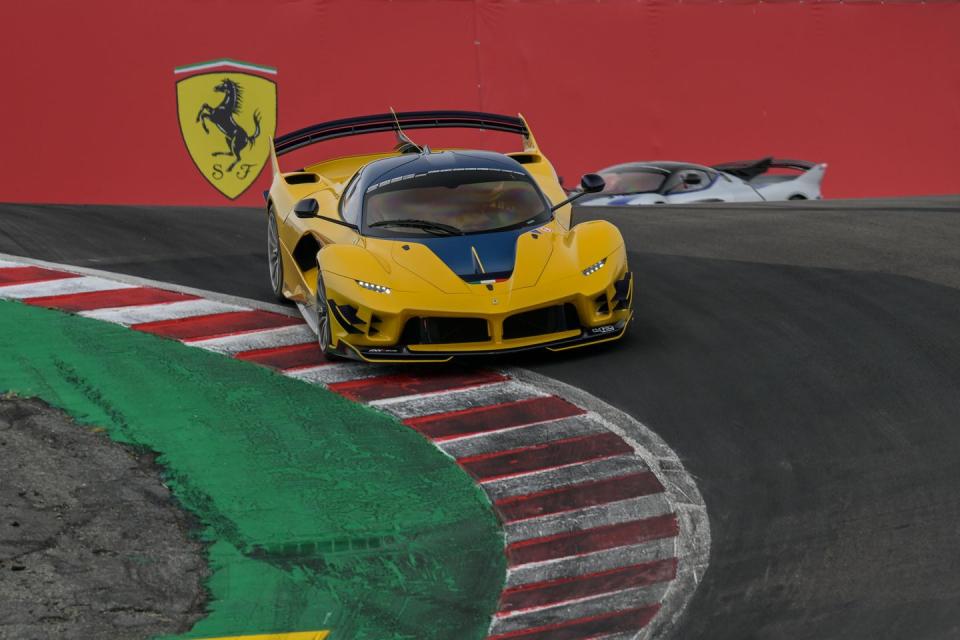 a yellow race car on a race track