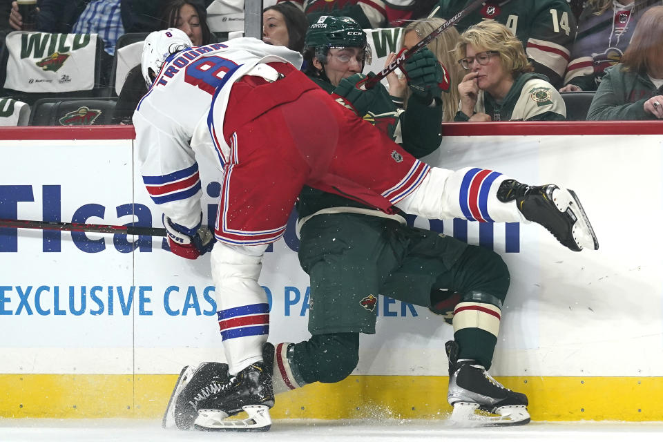 New York Rangers defenseman Jacob Trouba (8) and Minnesota Wild center Connor Dewar collide during the first period of an NHL hockey game Thursday, Oct. 13, 2022, in St. Paul, Minn. (AP Photo/Abbie Parr)