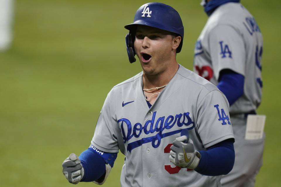 Los Angeles Dodgers' Joc Pederson celebrates his two RBI-single against the Tampa Bay Rays during the seventh inning in Game 4 of the baseball World Series Saturday, Oct. 24, 2020, in Arlington, Texas. (AP Photo/Eric Gay)