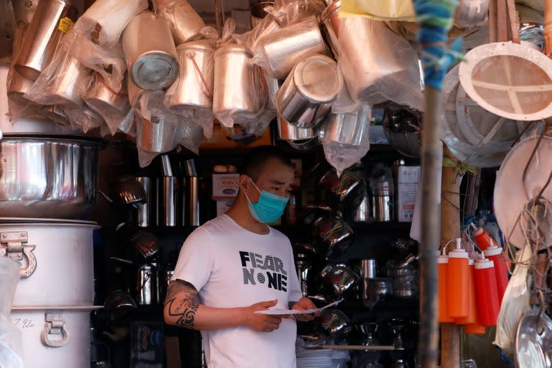 A man wears a protective mask following an outbreak of the coronavirus disease (COVID-19), while shopping at market in Karachi