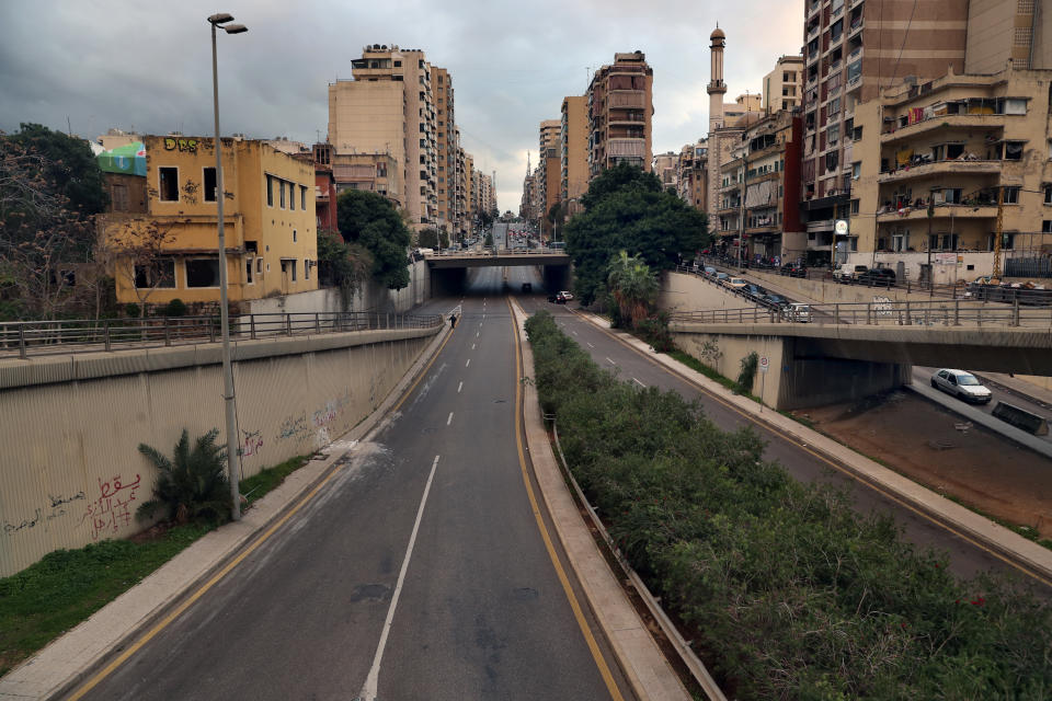 A street is empty of cars during a lockdown aimed at curbing the spread of the coronavirus, in Beirut, Lebanon, Friday, Jan. 15, 2021. Lebanon's parliament has approved a draft law to allow the importing of vaccines into the tiny country to fight the spread of coronavirus. (AP Photo/Bilal Hussein)