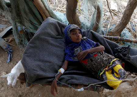 Afaf Hussein, 10, who is malnourished, lies inside a hut as she receives an injection near her family's house in the village of al-Jaraib, in the northwestern province of Hajjah, Yemen, February 20, 2019. REUTERS/Khaled Abdullah