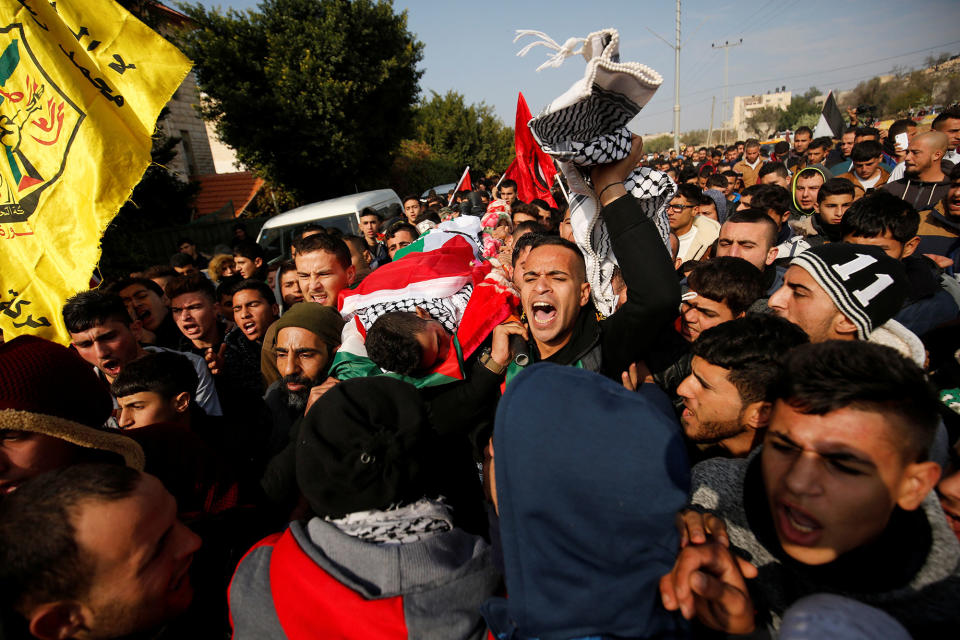 Mourners carry the body of a Palestinian assailant in Qabatya, West Bank