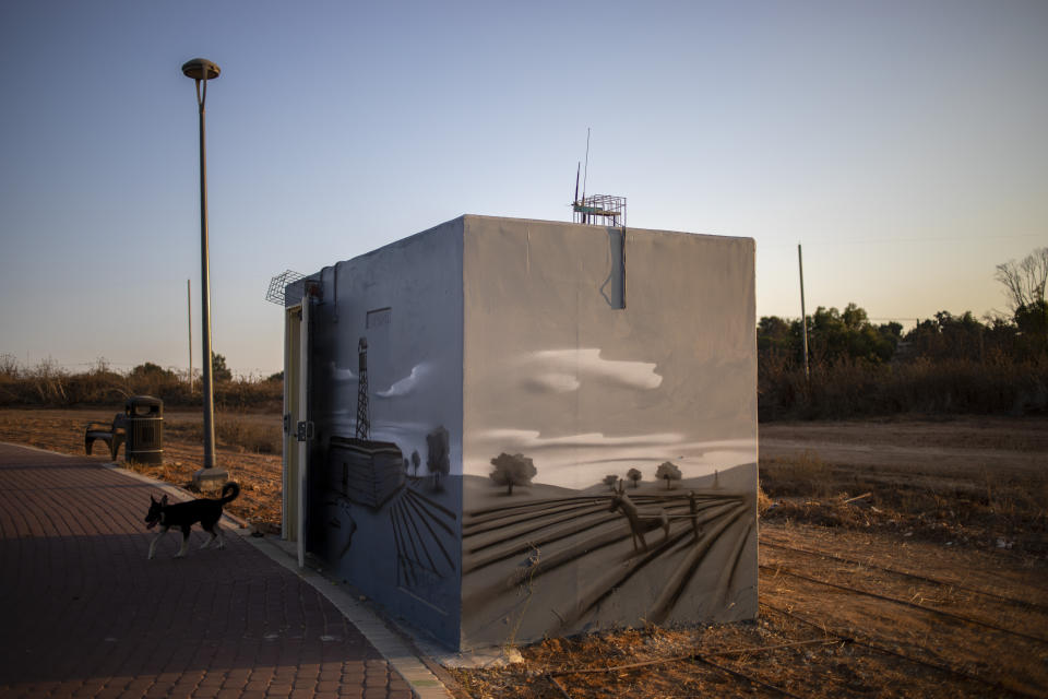 The door of a painted concrete bomb shelter is open for emergencies, at a public park in Sderot, Israel, Wednesday, July 28, 2021.No place in Israel has been hit harder by Palestinian rocket fire than Sderot, a working-class town just about a mile (1.5 kilometers) from the Gaza border. Although Sderot is enjoying an economic boom and revival, a generation of children and parents are suffering from the traumatic effects of two decades of rocket fire that experts are still struggling to understand. (AP Photo/Ariel Schalit)