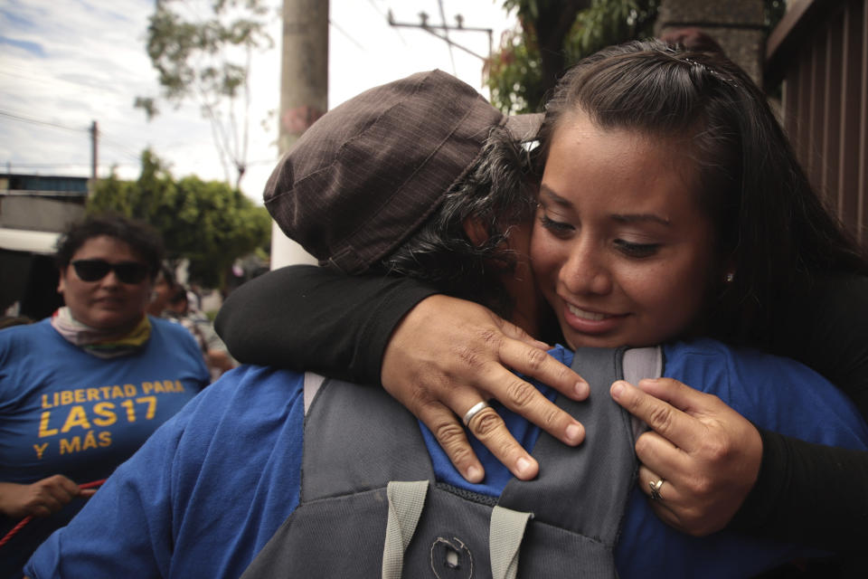 Evelyn Hernandez, 21, gets a hug after being acquitted on charges of aggravated homicide in her retrial related to the loss of a pregnancy in 2016, outside the court in Ciudad Delgado on the outskirts of San Salvador, El Salvador, Monday, Aug. 19, 2019. Hernandez, who has said she did not realize she was pregnant as the result of a rape when she gave birth into a latrine at 32 weeks, was originally sentenced to 30 years under El Salvador's strict abortion laws. (AP Photo/Salvador Melendez)