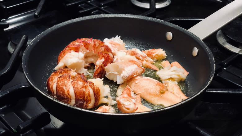 cooking lobster with butter in a pan