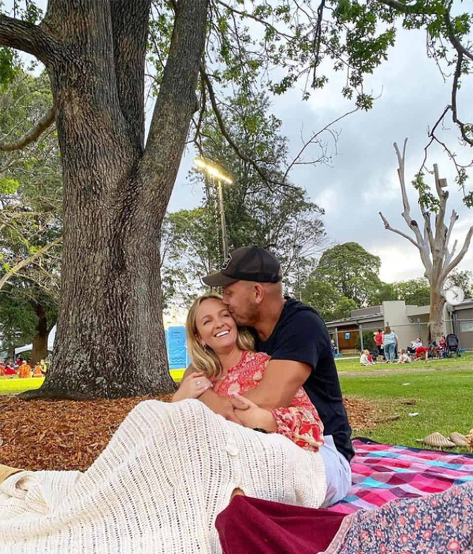 Becky Miles and her partner James kiss in the park