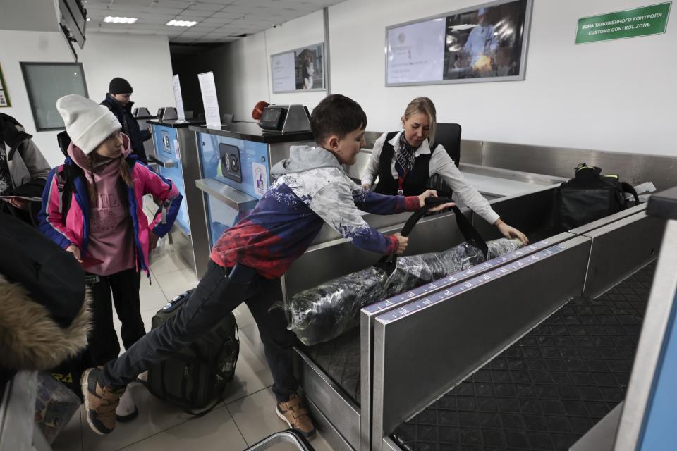 Russian tourists, members of the group traveling to North Korea first time since its borders closed due to the pandemic, check in to board a plane to fly to North Korea, at the international airport outside in Vladivostok, Russia's far east region of Primorsky Krai, Friday, Feb. 9, 2024. The four-day tour will depart on Feb. 9 and include stops in Pyongyang and a ski resort, according to an online itinerary. (AP Photo)