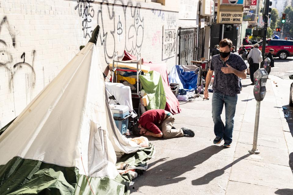 People and their belongings are seen on Jones Street in San Francisco, on Nov. 13, 2023.