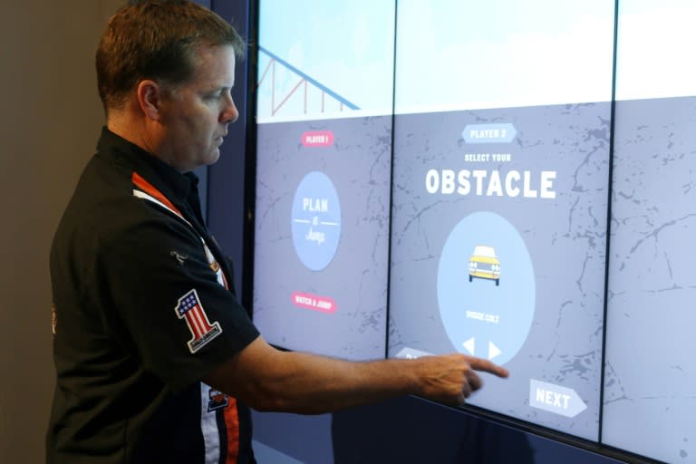 Mike Patterson, founder of The Evel Knievel Museum and owner of historic Harley-Davidson in Topeka, Kansas, shows how visitors can use their own variables in an interactive game to plan an Evel Knievel-inspired jump