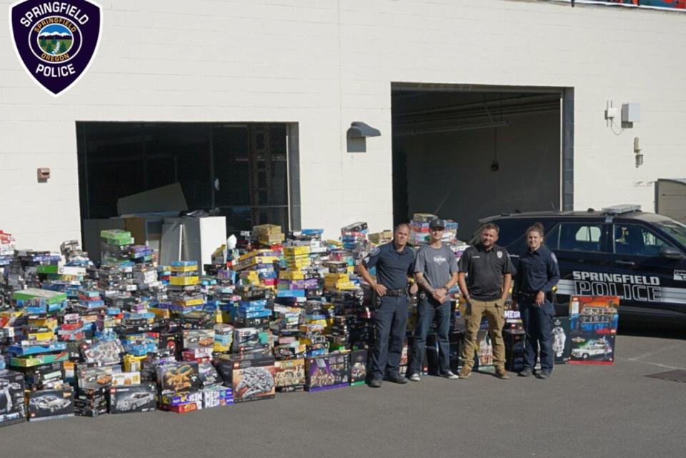 <p>Springfield Police Department </p> Authorities stand in front of stolen LEGO sets in Oregon