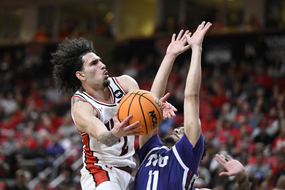 Texas Tech guard Pop Isaacs (2) attempts to shoot over TCU guard Trevian Tennyson (11) during the first half of an NCAA college basketball game Tuesday, Feb. 20, 2024, in Lubbock, Texas. (AP Photo/Justin Rex)