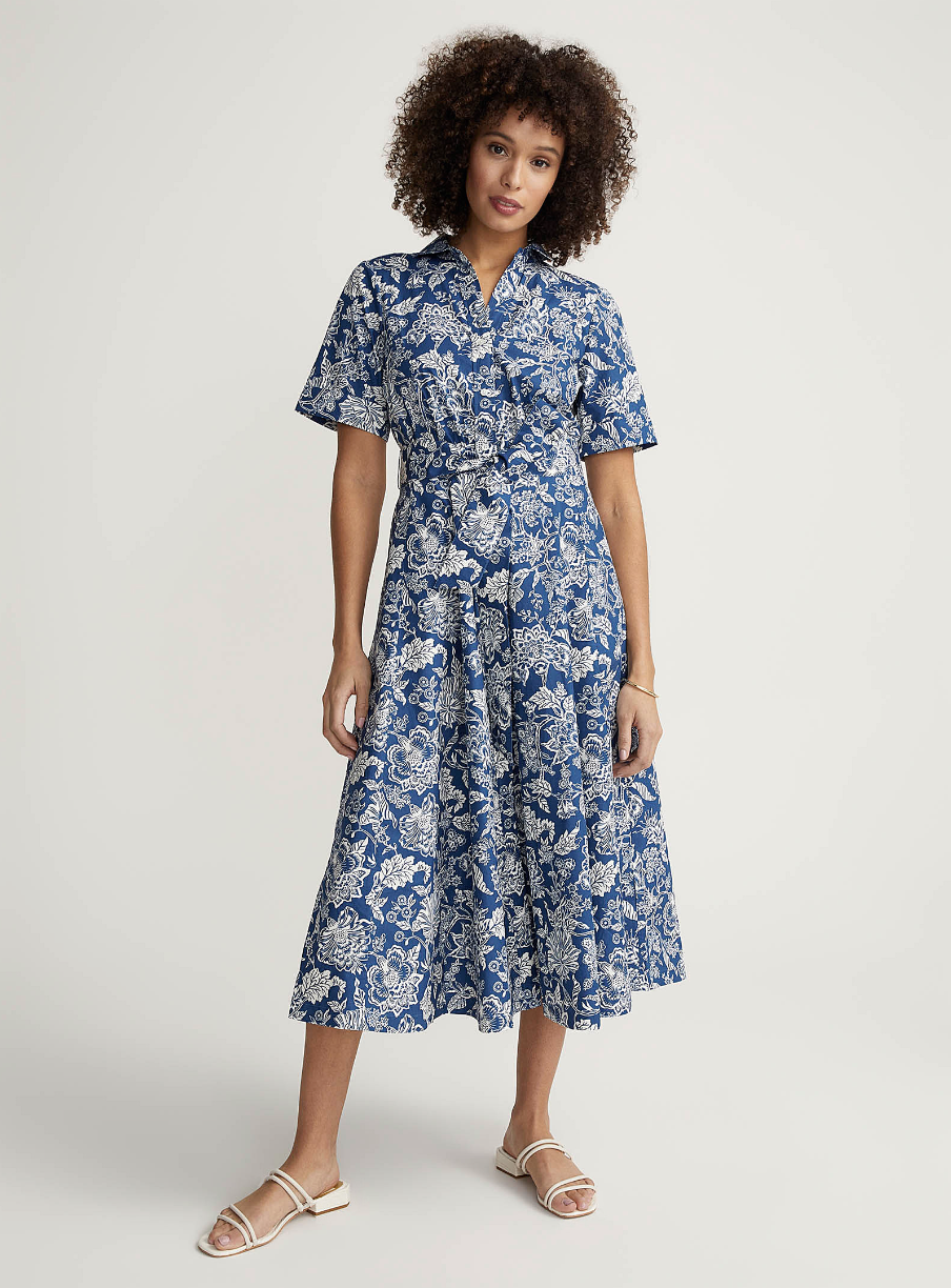 model with afro wearing blue and white printed floral Bright bouquet shirtdress (photo via Simons)