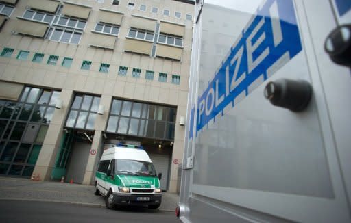 Police cars outside the main detention center in the Tempelhof district of Berlin. A porn actor dubbed the "Canadian Psycho" for allegedly killing and chopping up another man told a Berlin judge Tuesday he would not challenge his extradition from Germany