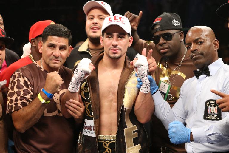 Danny Garcia (center) celebrates his knockout win over Rod Salka at the Barclays Center on August 9, 2014 in Brooklyn, New York