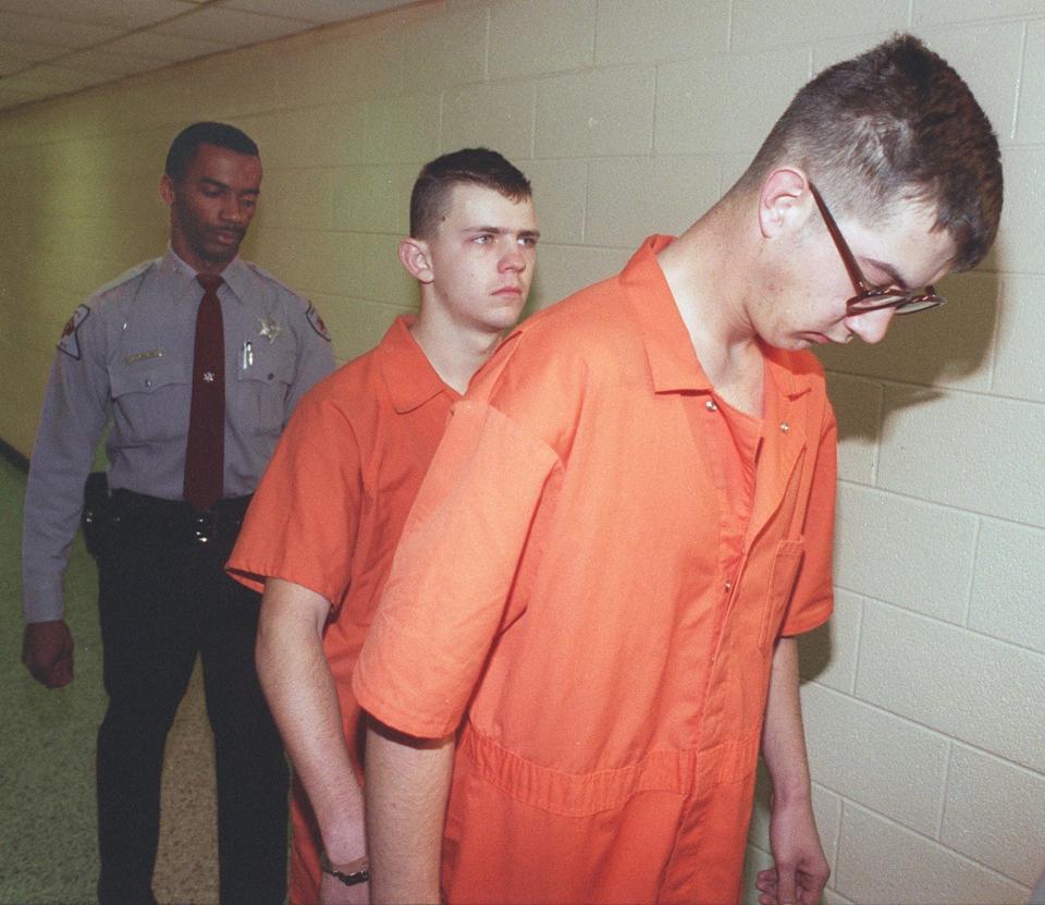 Cumberland County Sheriff's Deputy Andrew D. Melvin walks Malcolm Wright, 21, left, and James Norman Burmeister II, 20, to the courthouse on, Dec 8, 1995.  Wright and Burmeister, both Fort Bragg soldiers, were charged with murdering Michael James and Jackie Burden shortly after midnight on Dec 7,1995. The crime was racially motivated.