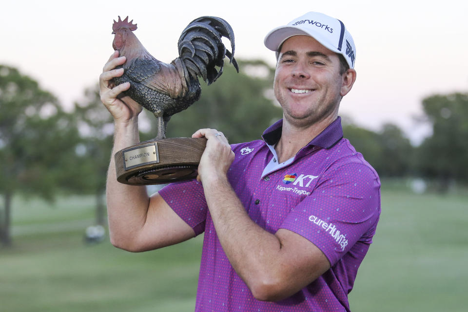 Luke List holds up the trophy after winning the Sanderson Farms Championship golf tournament in Jackson, Miss., Sunday, Oct. 8, 2023. (James Pugh/impact601.com via AP)