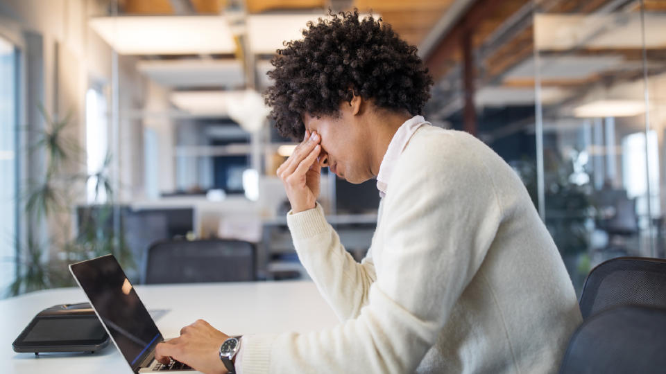 man working in an office feeling stressed