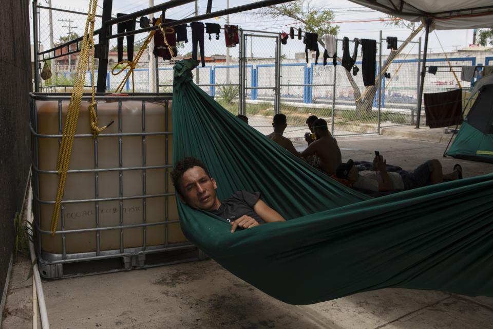 A migrant rests in his hammock at a shelter at the border town of Matamoros, Mexico, Wednesday, Aug. 16, 2023. Mexico’s immigration agency and a Catholic aid group have opened a temporary outdoor shelter for migrants living in camps to move to, as Mexico’s National Institute for Migration wants this large camp in Matamoros dismantled. (AP Photo/Jacky Muniello)
