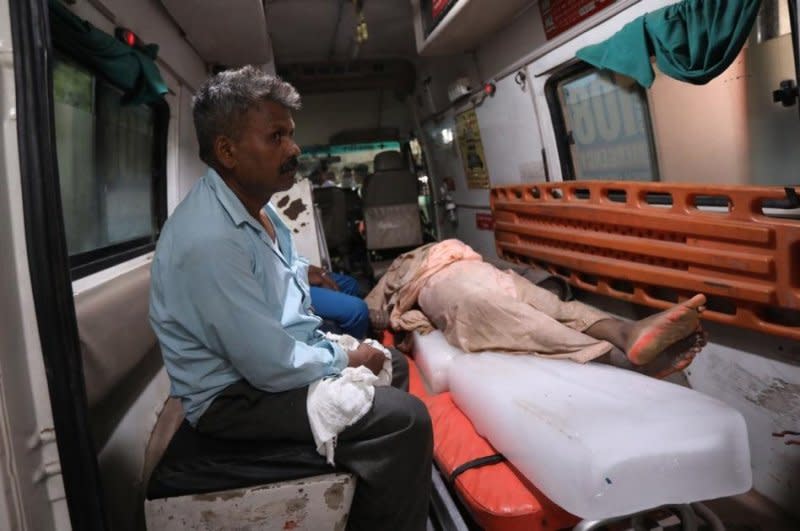 A victim is rushed to a local hospital after a human stampede killed at least 116 as a Hindu religious event ended in the Uttar Pradesh state of India Tuesday. Photo by Harish Tyagi/EPA-EFE