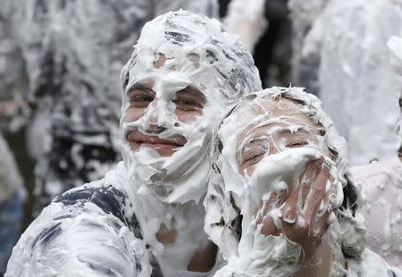 Students from St Andrews University are covered in foam as they take part in the traditional 'Raisin Weekend' in the Lower College Lawn, at St Andrews in Scotland October 17, 2016. REUTERS/Russell Cheyne