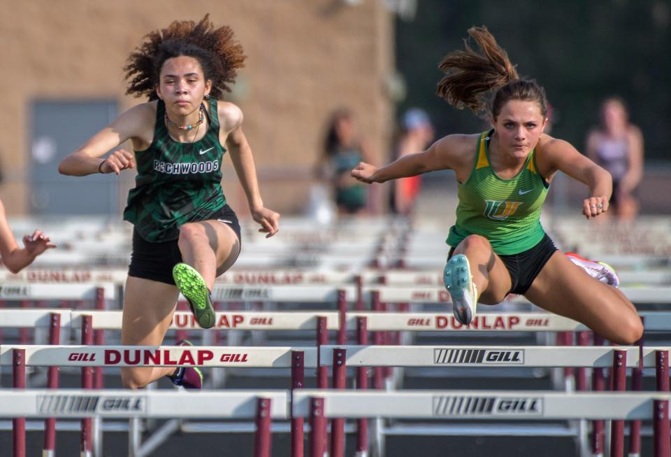 Richwoods' Mia Jackson, left, races neck-and-neck with Normal U-High's Anna Barr in the 100-meter hurdles during the Class 2A Girls Dunlap Sectional track and field meet Wednesday, May 11, 2022 at Dunlap High School. 