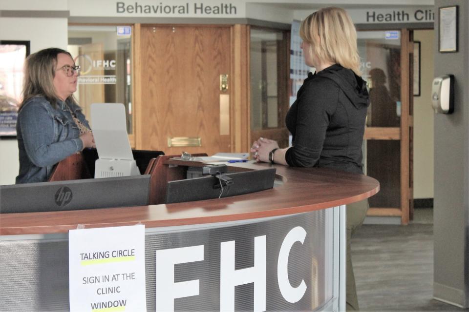 Rachael Arthur, executive director of the IFHC (left), and RN Kristen Laverclure (right) confer in the lobby of Great Falls' Indian Family Health Clinic.