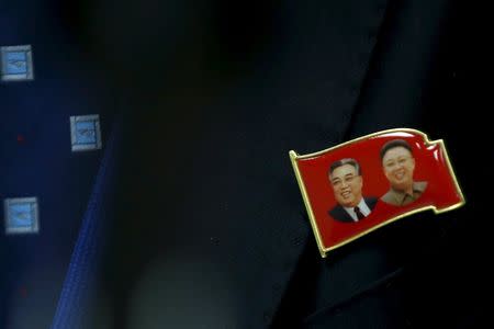 A lapel pin bearing the likeness' of former North Korean Leaders Kim il Sung (L) and Kim Jong-il (R) is seen on Ri Hung Sik, Ambassador at-large of the North Korean Foreign Ministry during a news conference at the North Korean Mission to the United Nations in New York, November 17, 2015. REUTERS/Mike Segar