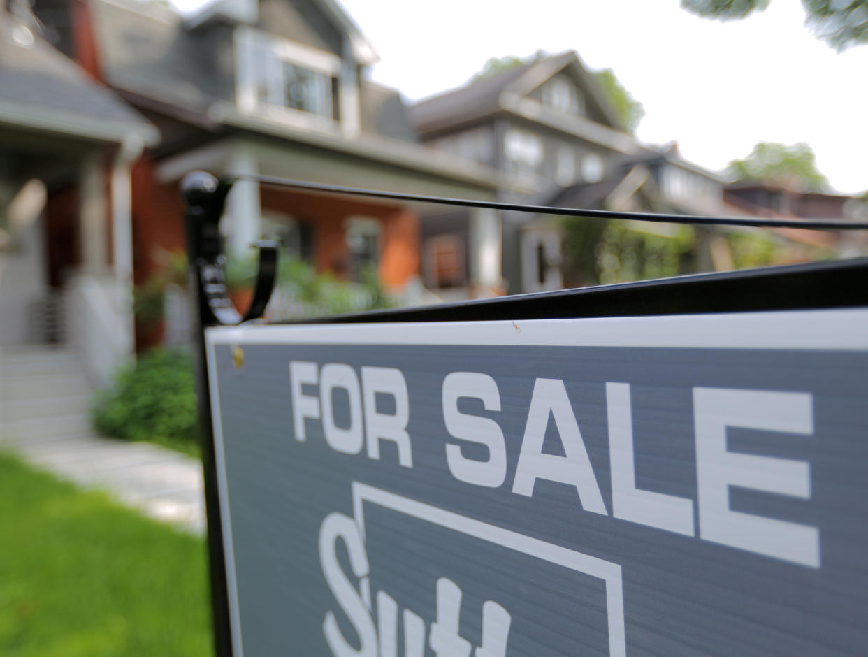 FILE PHOTO: A sign advertises a house for sale on a residential street in midtown Toronto, Ontario, Canada, July 12, 2017. REUTERS/Chris Helgren/File Photo