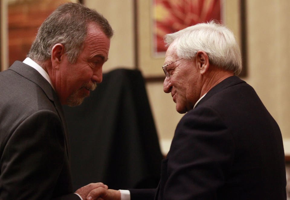 Mayor of Lubbock Glen Robertson, left greets the Executive Director and President of the National Exhibits Association Rev. Malcolm Neyland at the Overton Hotel and Conference Center during an announcement of an exhibit displaying artifacts from Pope John Paul the II is coming to Lubbock Thursday, Nov. 29, 2012. Over 130 items are expected to be on display between March 15, 2013 and May 31, 2013 at The Catholic Renewal Center of the Diocese of Lubbock. (AP Photo/Lubbock Avalanche-Journal, Stephen Spillman)