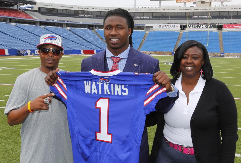 Buffalo Bills first round draft pick Sammy Watkins poses for photos with his father James McMiller, left, and mother Nicole McMiller at Ralph Wilson Stadium in Orchard Park, N.Y., Friday, May 9, 2014. (AP Photo/Bill Wippert)