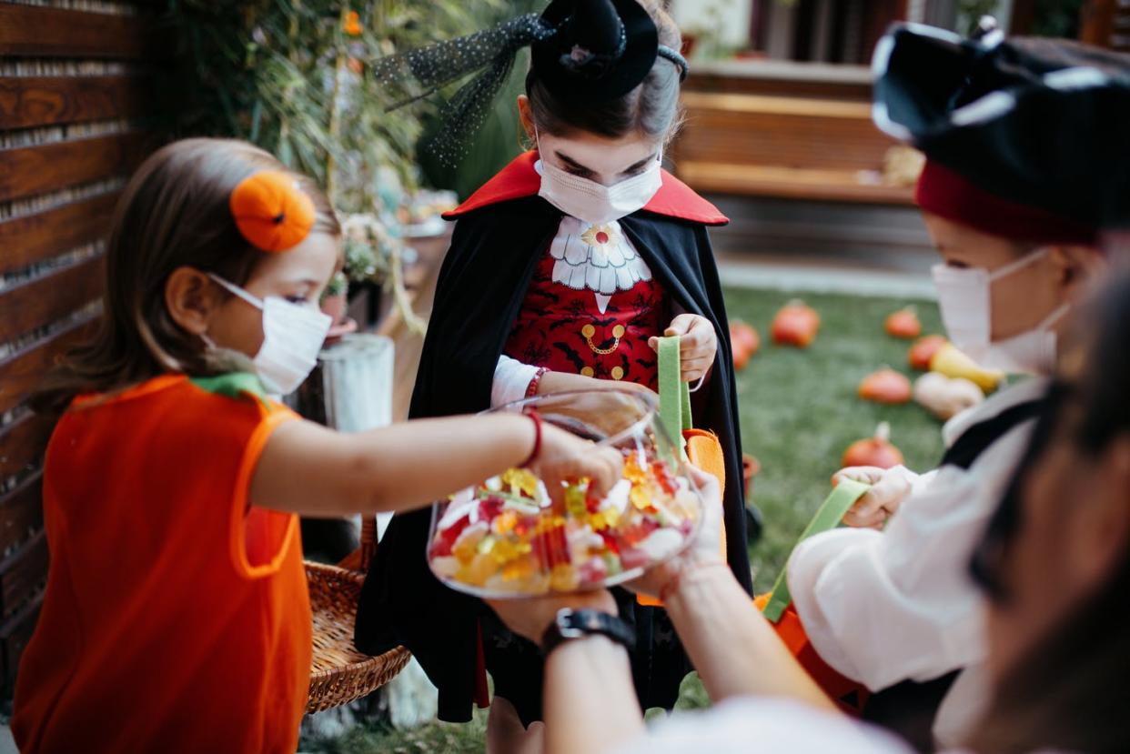 <span class="caption">Experts give trick-or-treating the green light this year.</span> <span class="attribution"><a class="link " href="https://www.gettyimages.com/detail/photo/little-kids-at-a-halloween-party-royalty-free-image/1270677135" rel="nofollow noopener" target="_blank" data-ylk="slk:Anchiy/E+ Collection via Getty Images;elm:context_link;itc:0;sec:content-canvas">Anchiy/E+ Collection via Getty Images</a></span>