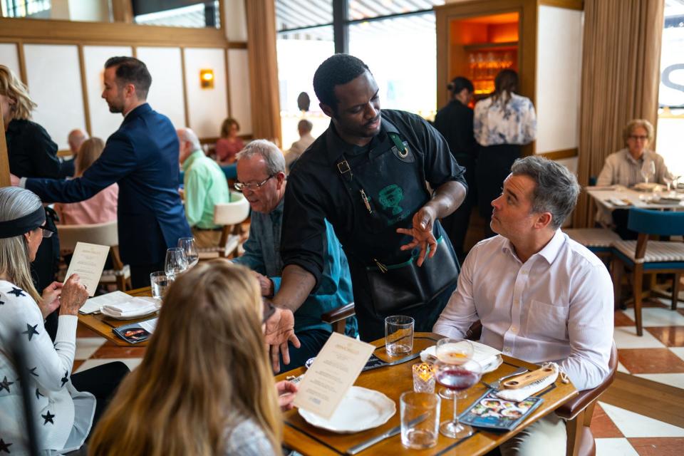 San Morello waiter Teddy Jones discusses the menu with Josh Robinson of Novi and Erin Robinson of Novi during the Detroit Free Press / Metro Detroit Chevy Dealers Top 10 Takeover at San Morello in downtown Detroit on Tuesday, April 23, 2019.