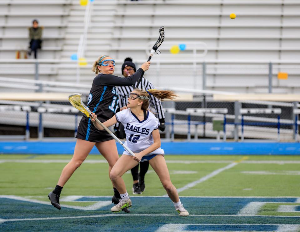 Plymouth South's Madison Miller takes the face-off against Plymouth North’s Addie Pyy

.